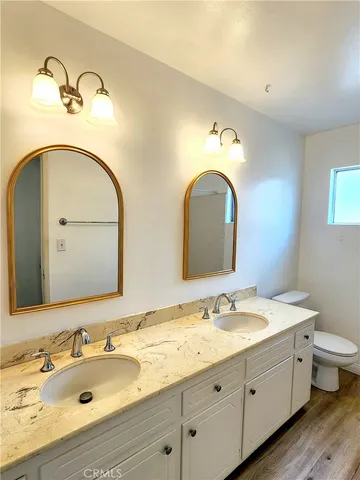 a bathroom with a double vanity sink and a mirror