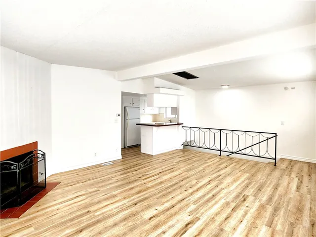 a view of a room with a sink and wooden floor
