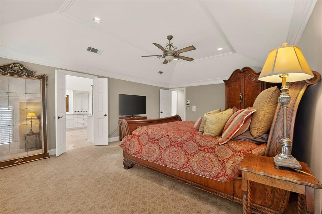 2405 Wing Point Lane Plano, TX 75093 - Photo 21 of 39 a bedroom with a bed and a flat screen tv