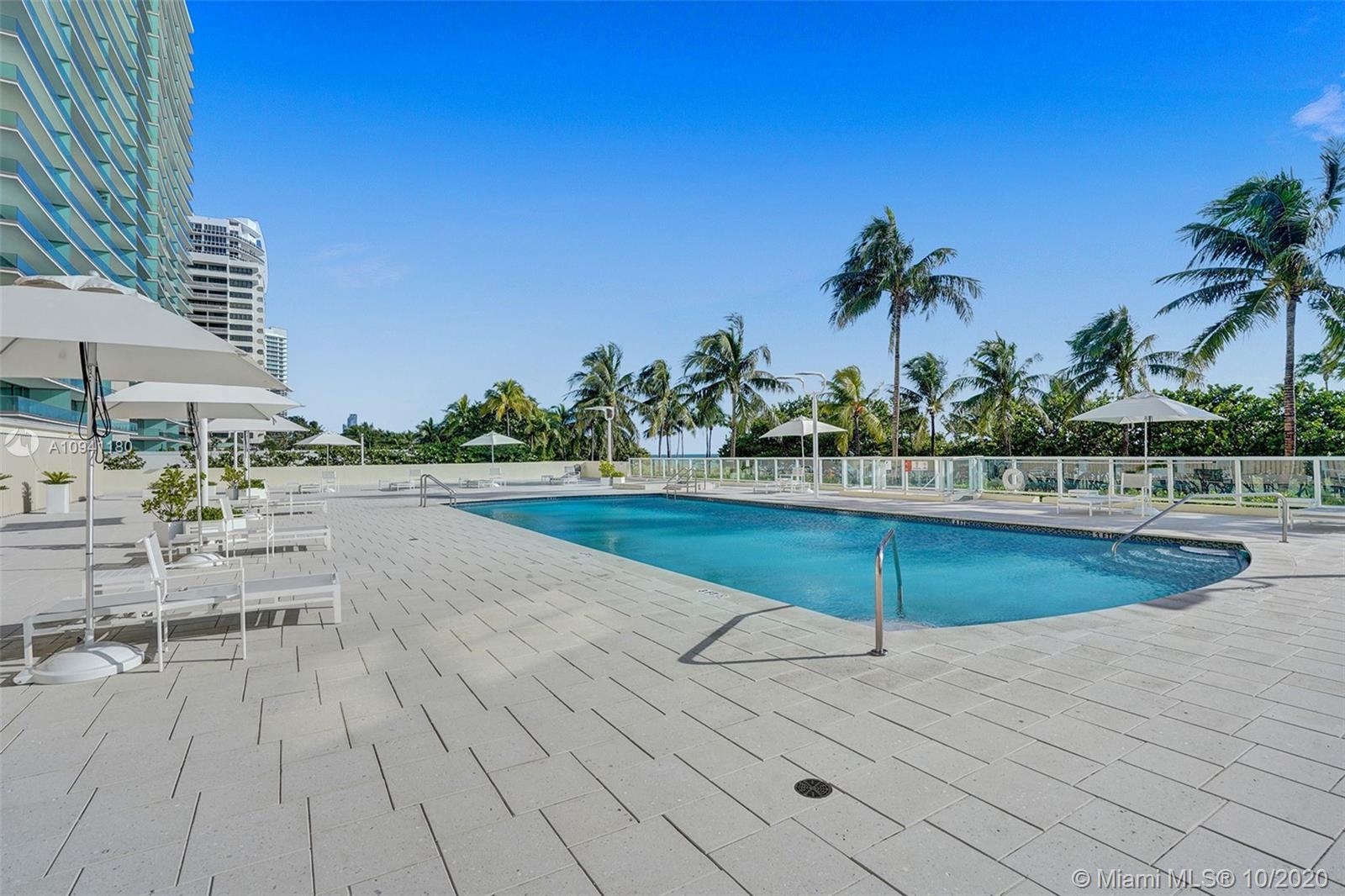 10185 Collins Avenue, Unit 818 Bal Harbour, FL 33154 - Photo 19 of 41 a view of a swimming pool with chairs