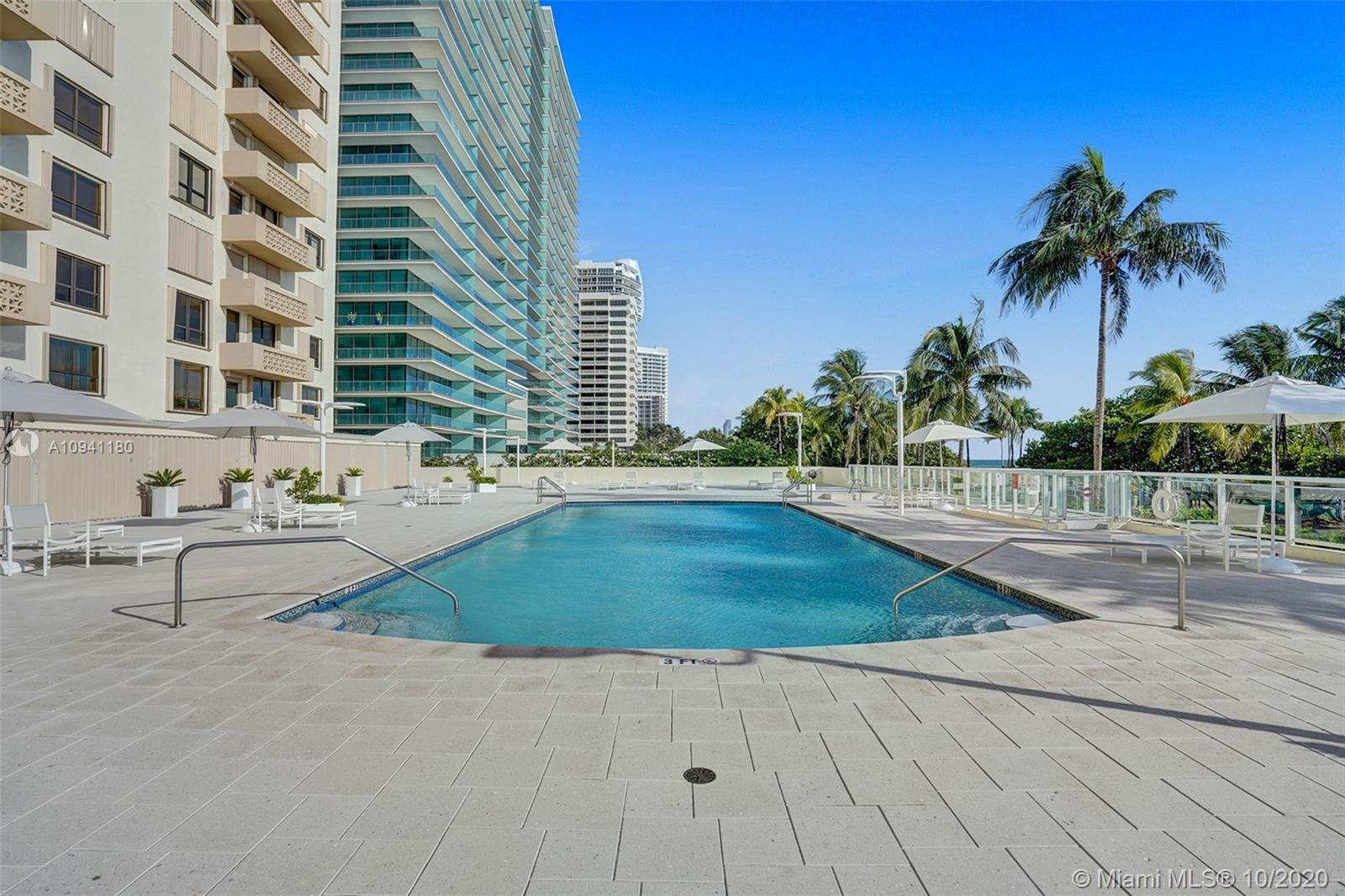 10185 Collins Avenue, Unit 818 Bal Harbour, FL 33154 - Photo 20 of 41 a swimming pool with outdoor seating and yard