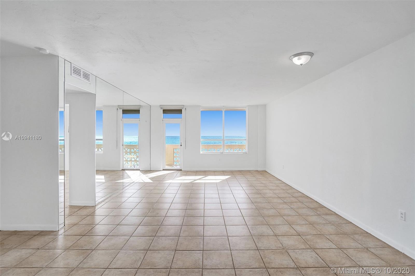 10185 Collins Avenue, Unit 818 Bal Harbour, FL 33154 - Photo 3 of 41 a view of an empty room with window and chandelier fan