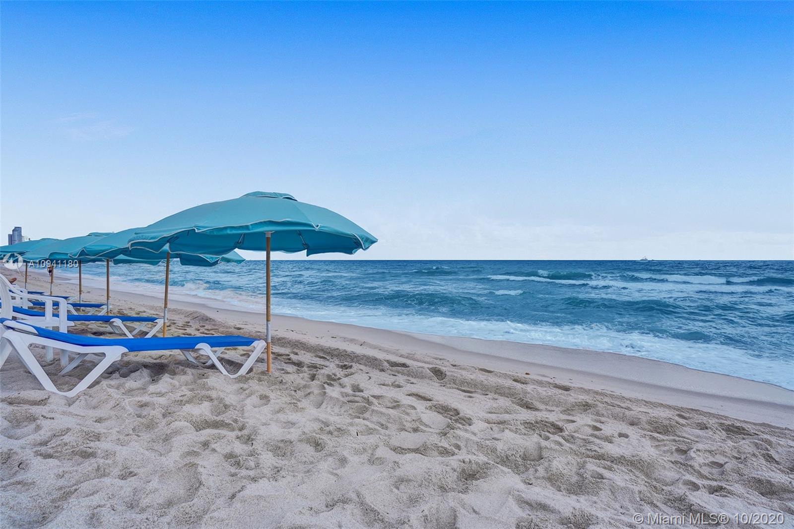 10185 Collins Avenue, Unit 818 Bal Harbour, FL 33154 - Photo 32 of 41 a backyard of a house with table and chairs