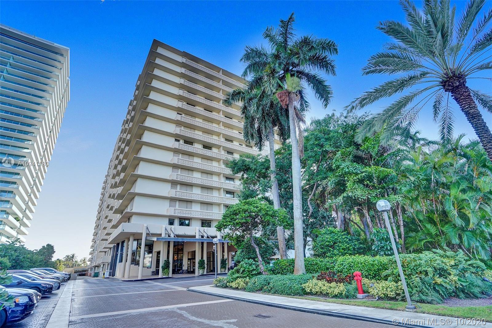 10185 Collins Avenue, Unit 818 Bal Harbour, FL 33154 - Photo 34 of 41 a front view of multi story residential apartment building with yard and sign board