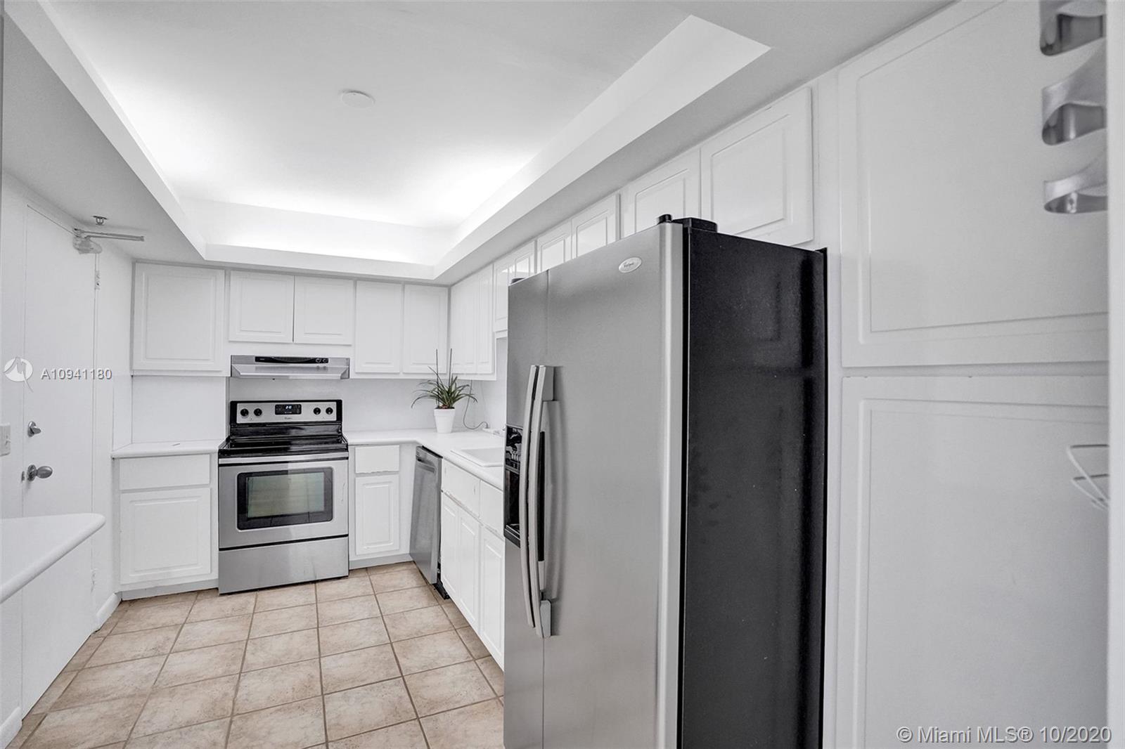 10185 Collins Avenue, Unit 818 Bal Harbour, FL 33154 - Photo 10 of 41 a kitchen with stainless steel appliances granite countertop a refrigerator and a stove top oven