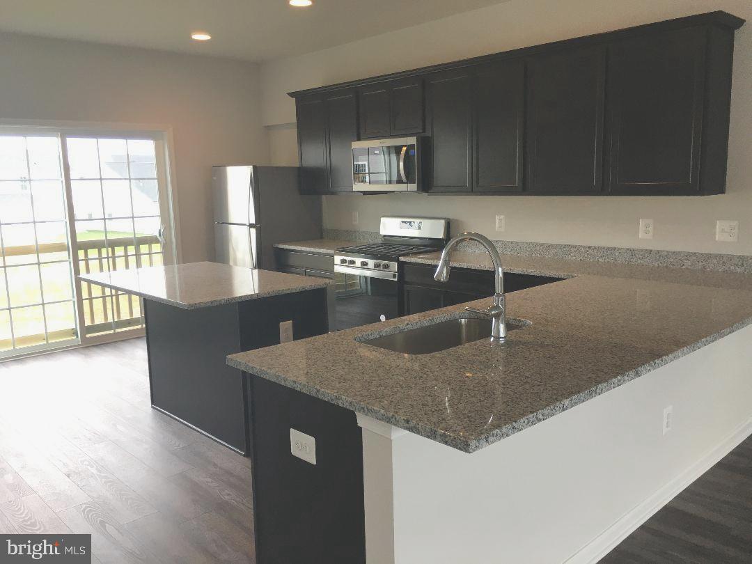 145 Jewel Stephenson, VA 22656 - Photo 2 of 15 a kitchen with stainless steel appliances granite countertop a sink a stove and a microwave with granite countertops