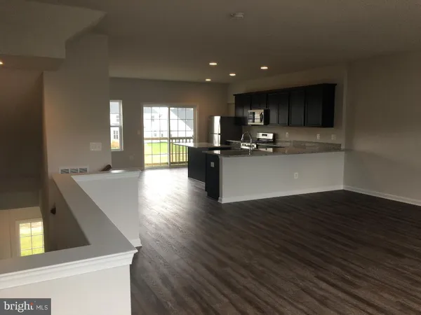 a open kitchen with a sink dishwasher stove and wooden cabinets