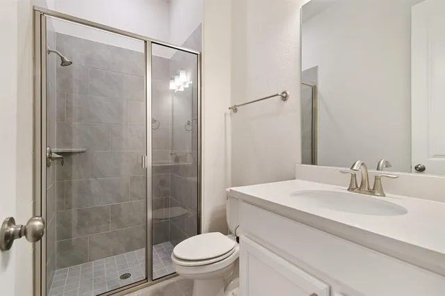 a bathroom with a toilet a sink a mirror and bathtub