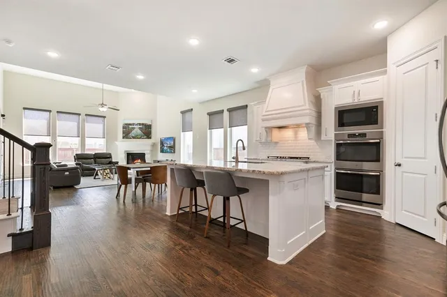 a kitchen with lots of counter top space and stainless steel appliances