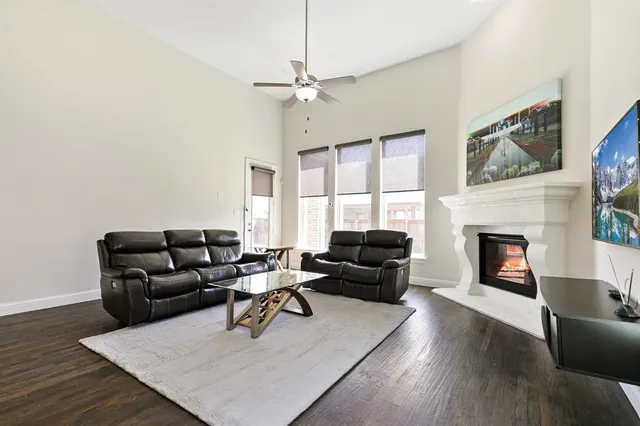a living room with furniture fireplace and window