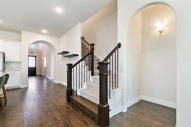 a view of entryway with wooden floor and stairs