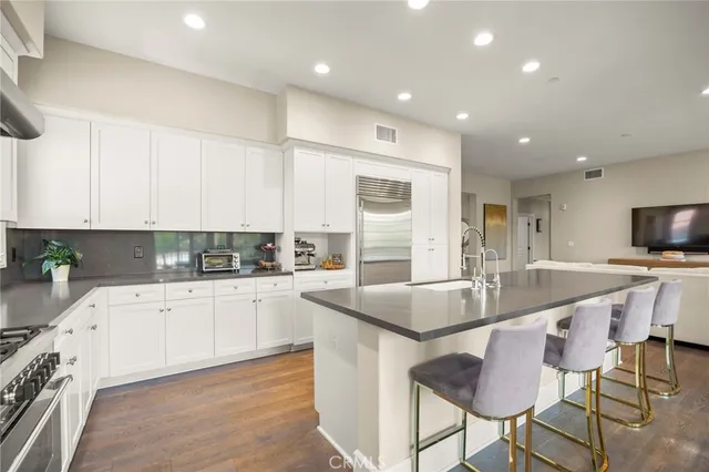 a kitchen with granite countertop kitchen island wooden cabinets and stainless steel appliances