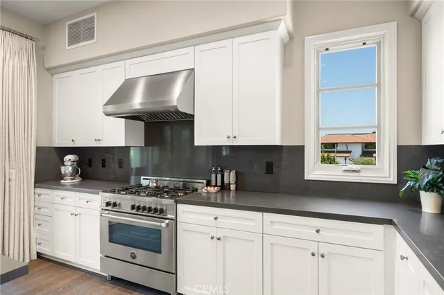 a kitchen with white cabinets and white appliances