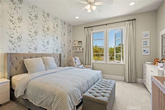 a spacious bedroom with a bed and a chandelier