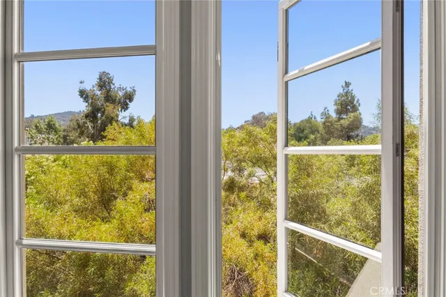 a spacious bedroom with a bed and a chandelier