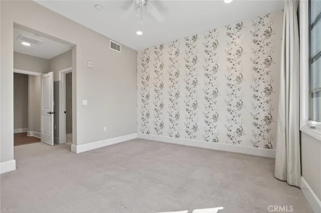 a bedroom with a large bed and a flat tv screen