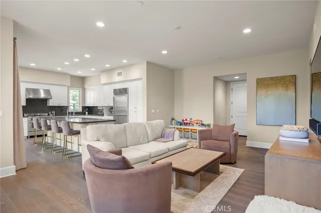 a living room with furniture a large window and a flat screen tv