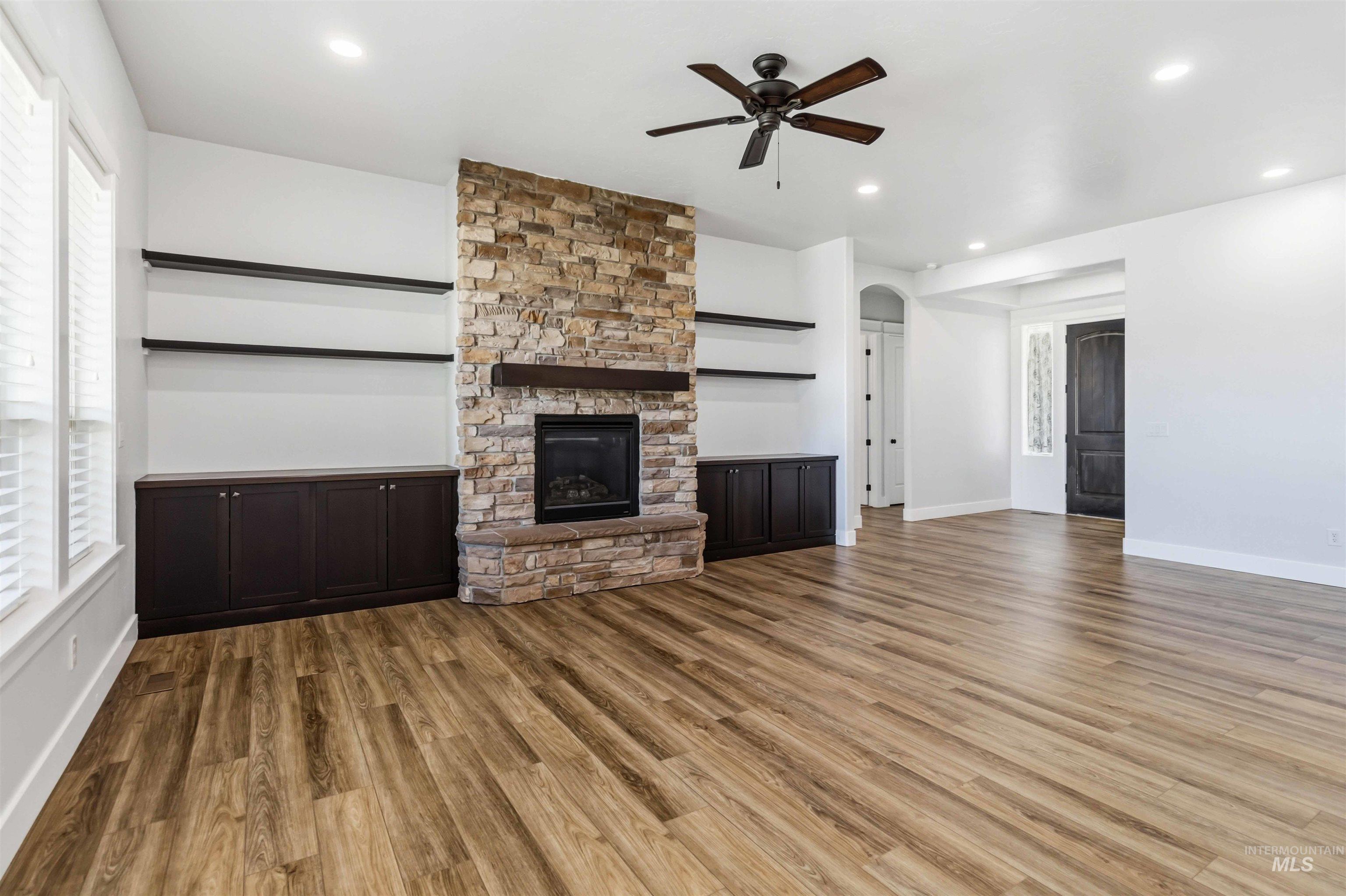 3218 North Cherry Laurel Way Star, ID 83669 - Photo 9 of 50 Stone-clad fireplace with dark wood mantle and hearth
