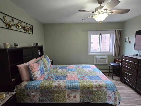 a bedroom with a bed and wooden floor