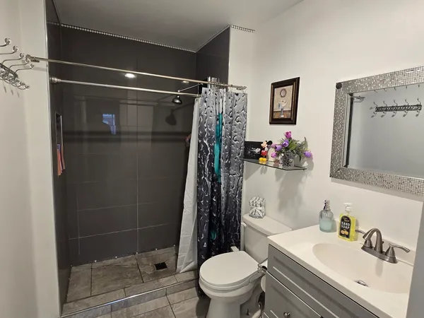 a bathroom with a sink toilet and shower