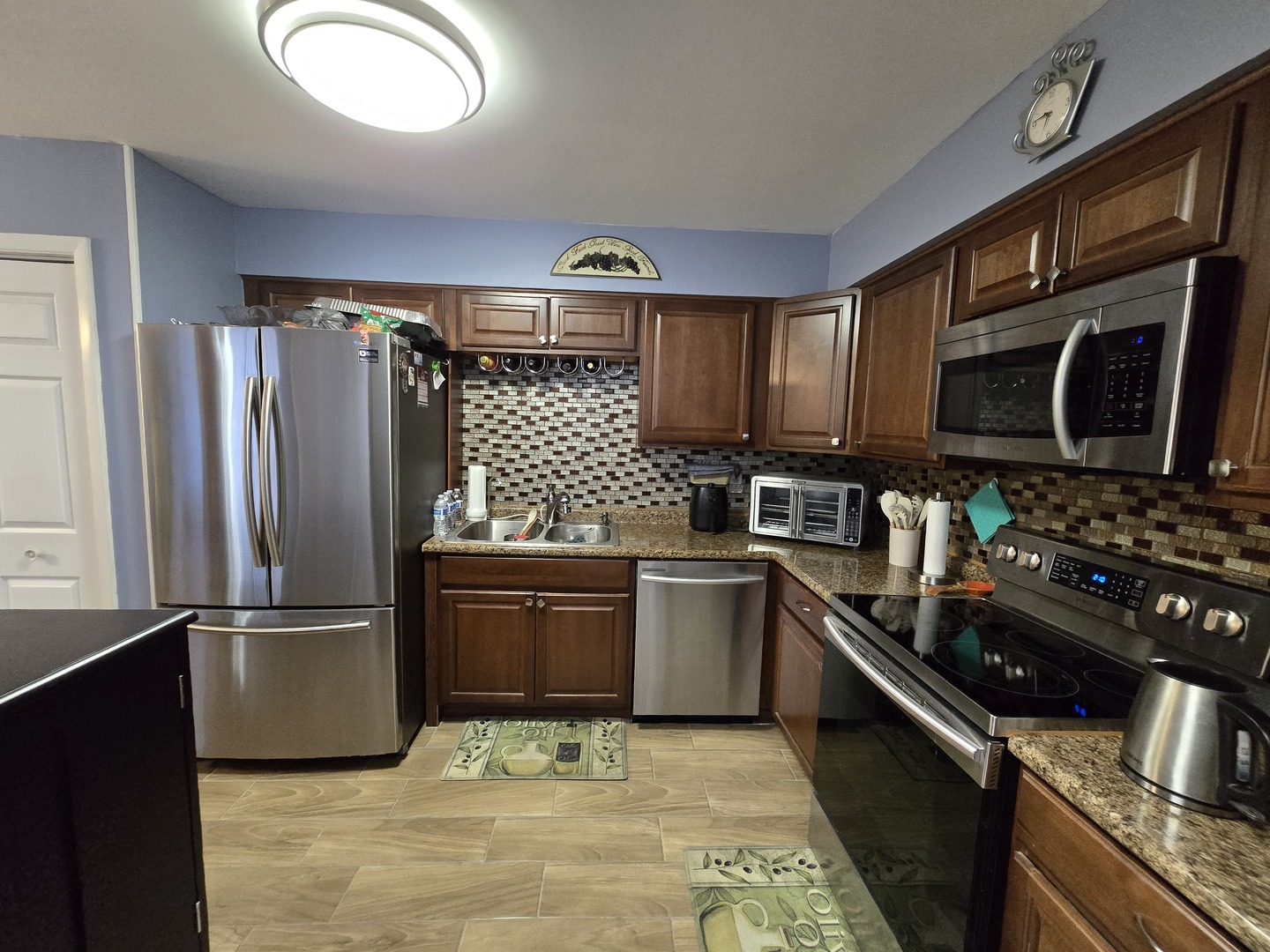 161 West Elk Trail, Unit 263 Carol Stream, IL 60188 - Photo 3 of 14 a kitchen with granite countertop stainless steel appliances and wooden cabinets