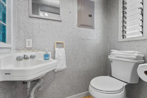 a white toilet sitting next to a bathroom sink
