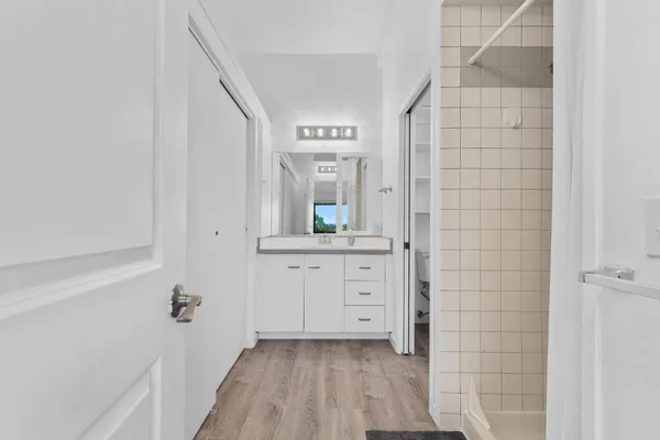a bathroom with a sink a mirror and shower