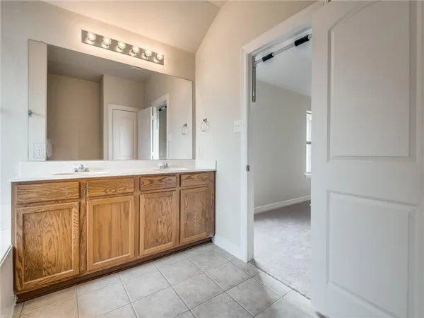 a bathroom with a granite countertop sink mirror and
