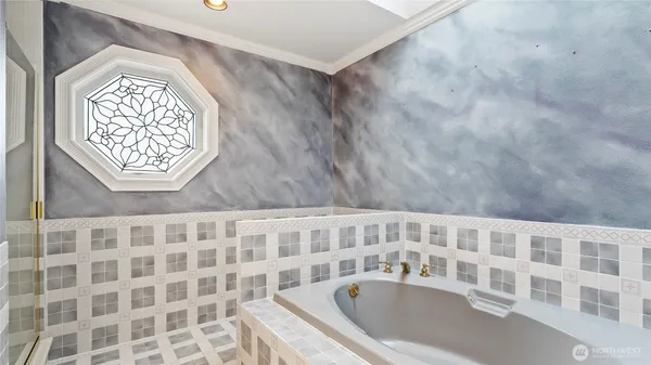 a bathroom with a bathtub and shower