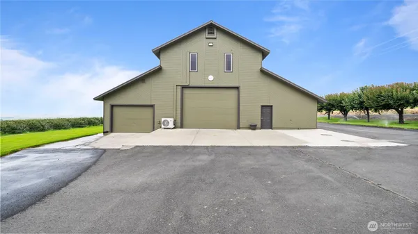a view of the house with a yard and garage