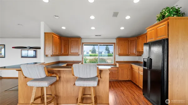 a kitchen with stainless steel appliances granite countertop a refrigerator and a stove top oven