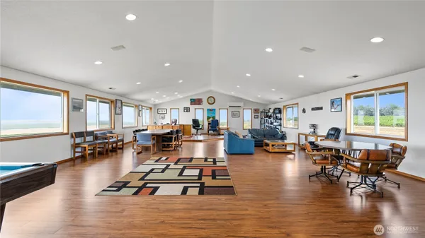 a living room with furniture hard wood floor and a table