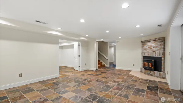 a view of empty room with a fireplace