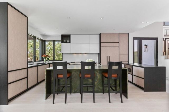 a dinning room with furniture a window and a bookshelf