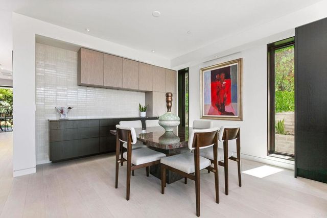 a dining room with furniture and wooden floor