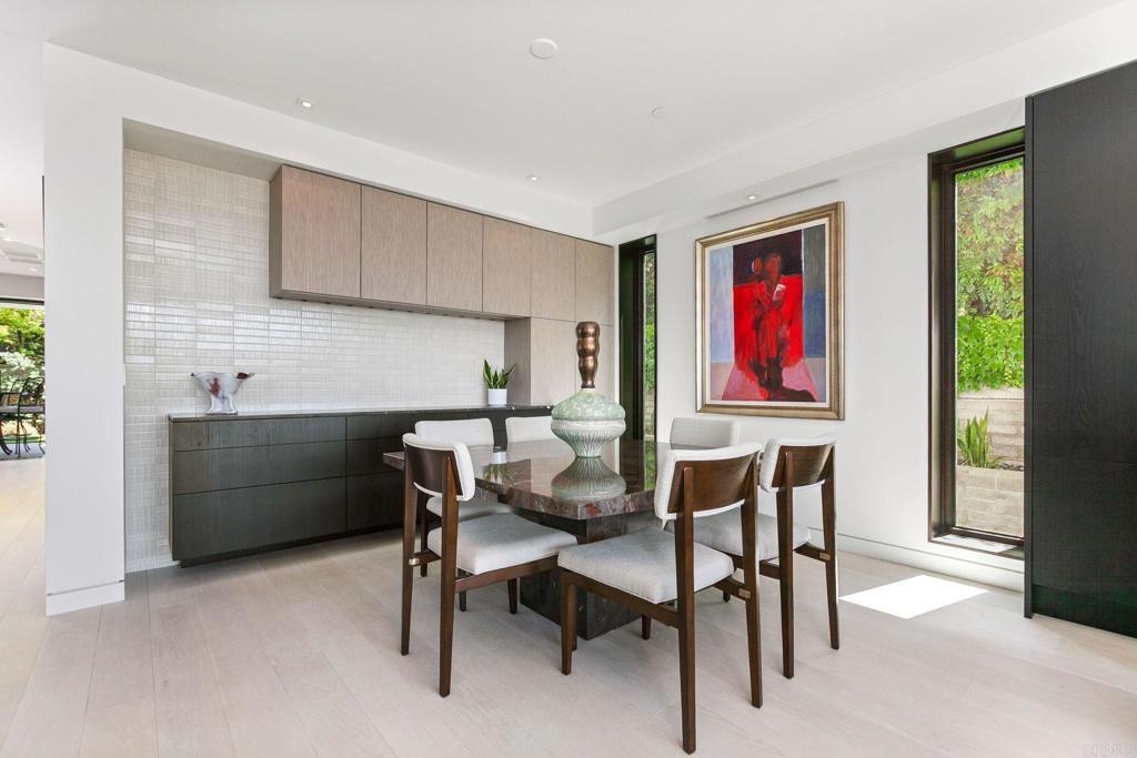 2045 Lowry Place La Jolla, CA 92037 - Photo 6 of 19 a dinning room with furniture a window and a bookshelf