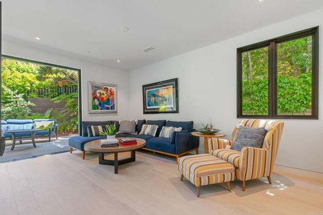 a large bedroom with a large bed and a flat screen tv