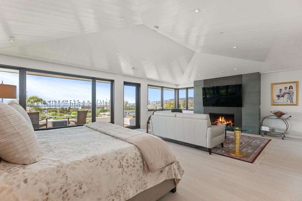 2045 Lowry Place La Jolla, CA 92037 - Photo 9 of 19 a large bedroom with a large bed and a flat screen tv