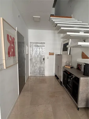 a kitchen with stainless steel appliances a stove a refrigerator and a microwave