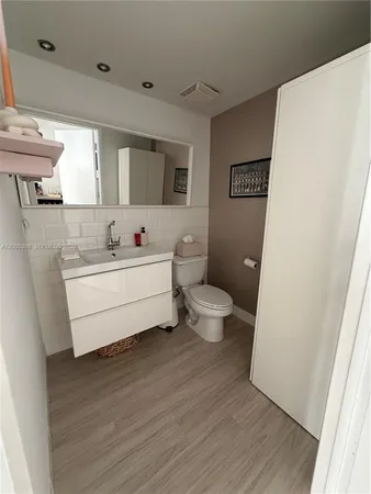 a bathroom with a bathtub sink mirror and toilet