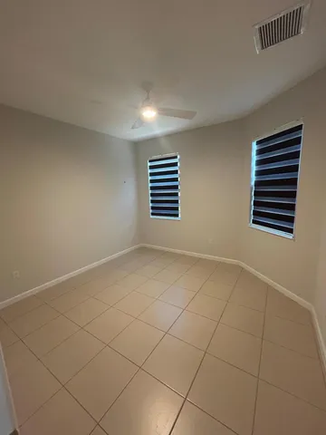an empty room with wooden floor and outdoor view