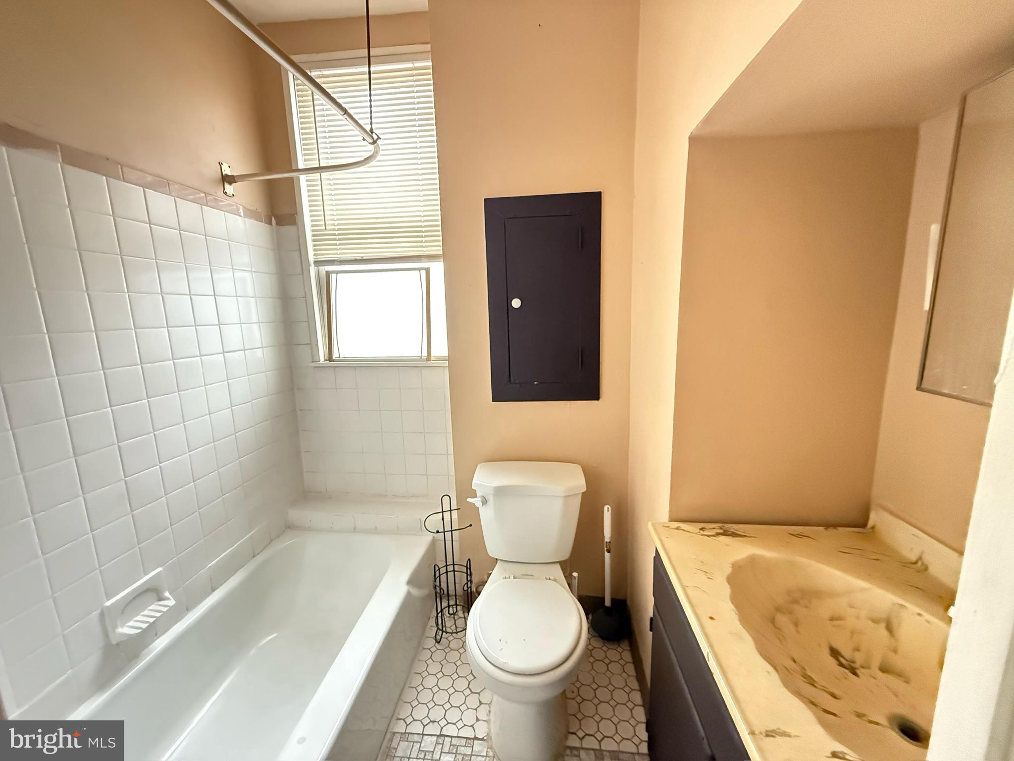 2219 Winton Street Philadelphia, PA 19145 - Photo 8 of 8 a bathroom with a granite countertop toilet a sink and bathtub