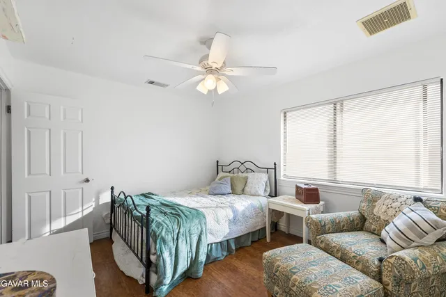 a bedroom with furniture and a large window