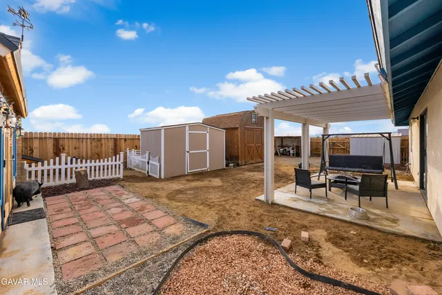 a view of a porch with furniture and floor to ceiling window