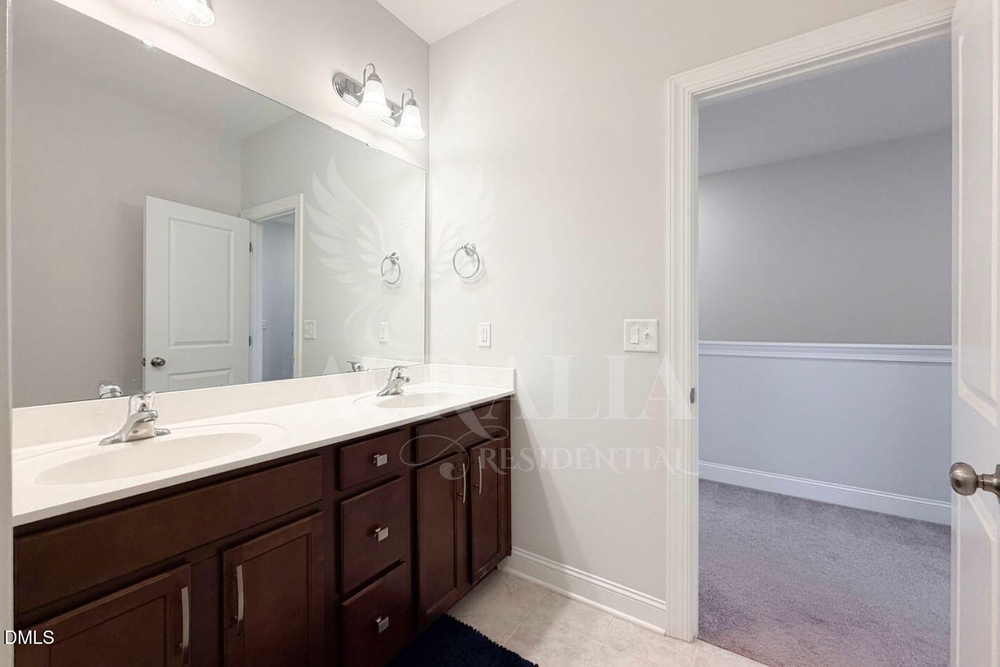 1306 Farm Pond Trail Durham, NC 27703 - Photo 21 of 46 a bathroom with a double vanity sink and a mirror