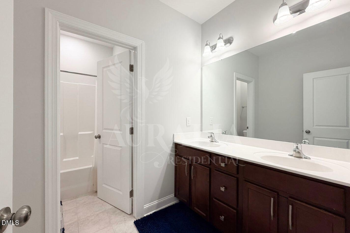 1306 Farm Pond Trail Durham, NC 27703 - Photo 22 of 46 a bathroom with a double vanity sink and mirror