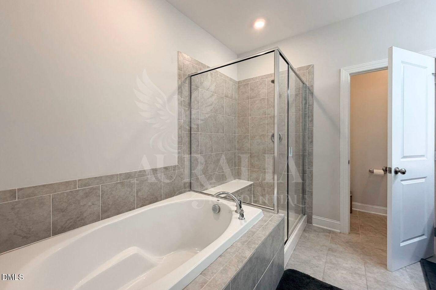 1306 Farm Pond Trail Durham, NC 27703 - Photo 28 of 46 a bathroom with a bathtub and a shower