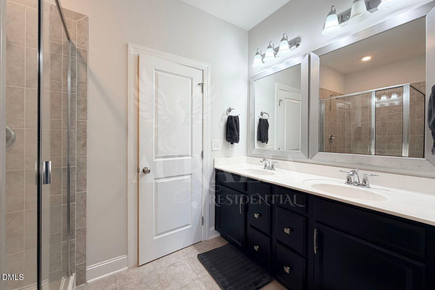 1306 Farm Pond Trail Durham, NC 27703 - Photo 29 of 46 a bathroom with double vanity and a mirror
