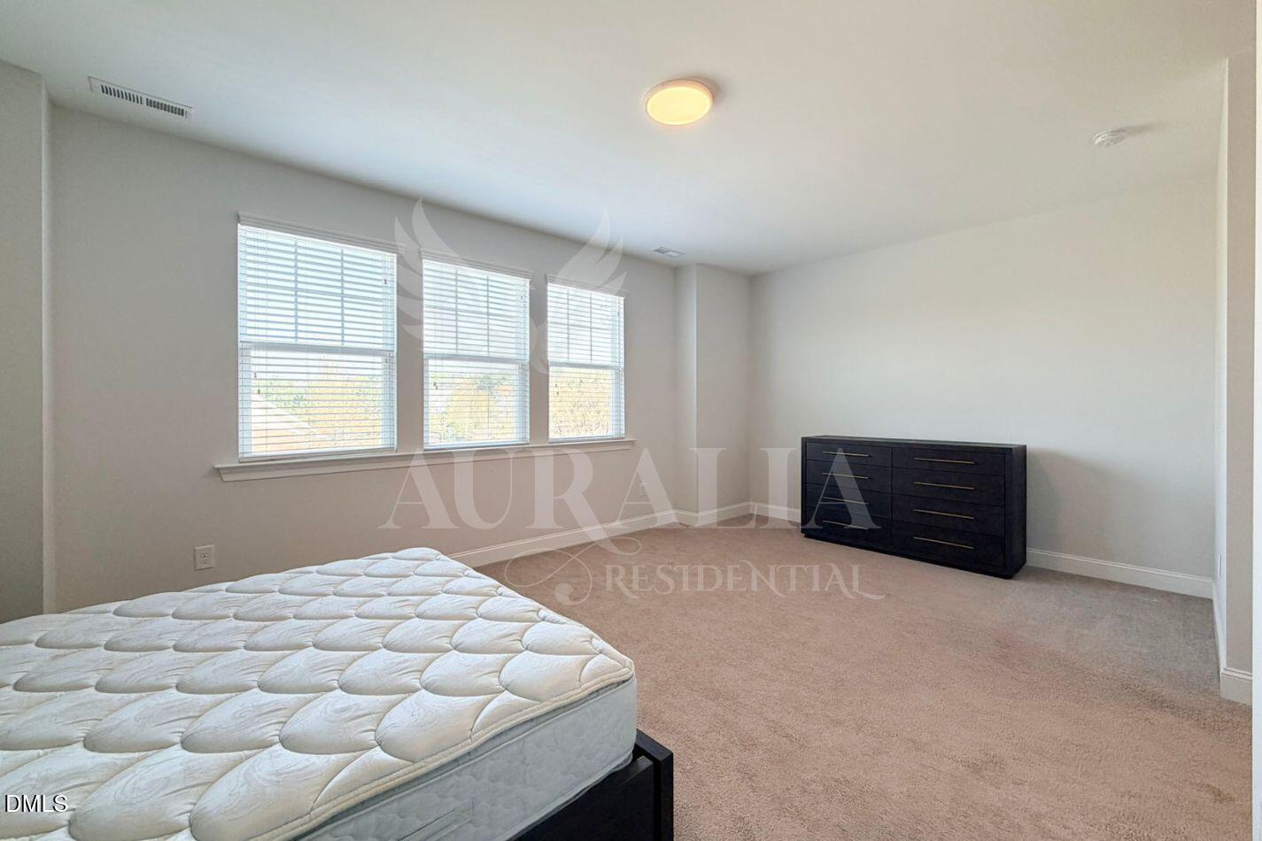 1306 Farm Pond Trail Durham, NC 27703 - Photo 32 of 46 a room with a bed and a window