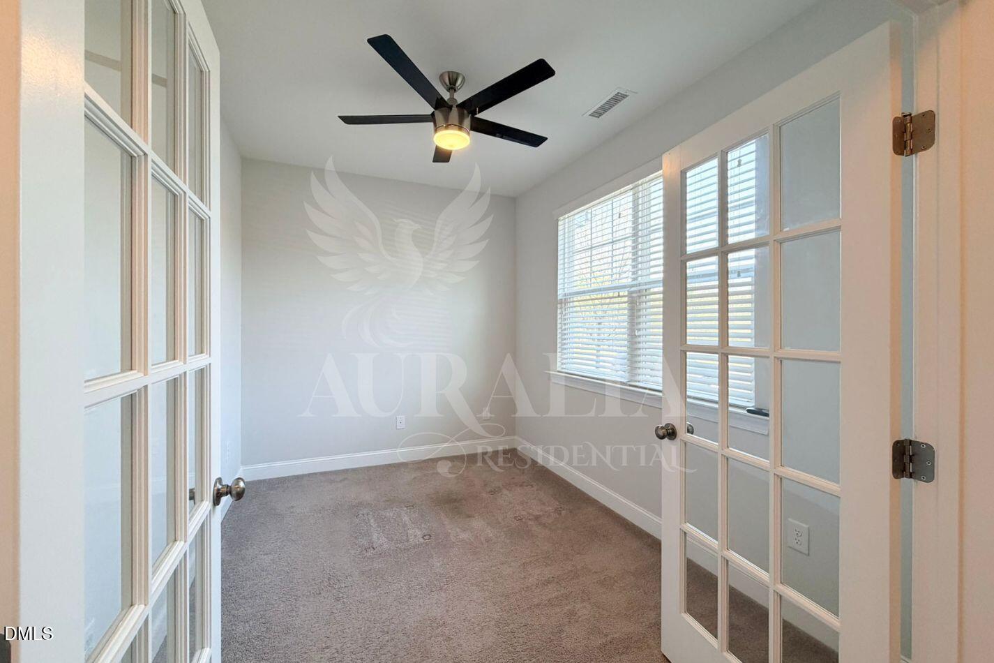 1306 Farm Pond Trail Durham, NC 27703 - Photo 4 of 46 a view of a livingroom with a ceiling fan and windows